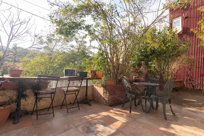 a patio with chairs and a table with a view at Calm & Charming 1BR with Shared Lush Garden Access in Istanbul