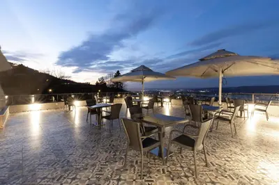 a group of tables and chairs with umbrellas at Best Western Plus Sapanca in Sapanca