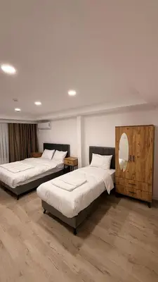 a bedroom with two beds and a mirror at Mütena konaklama in Mudanya