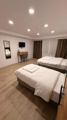 a bedroom with two beds and a television in it at Mütena konaklama in Mudanya