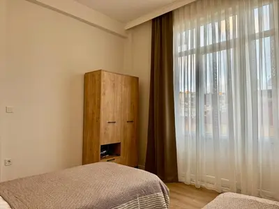 a bedroom with a bed and a dresser and a window at Nisantasi - Spacious and Modern Loft House in Istanbul