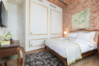 a bedroom with a bed and a brick wall at Hotel Pera Parma in Istanbul