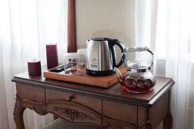 a coffee maker on a wooden table with candles at Hotel Pera Parma in Istanbul