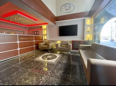 a waiting room with a couch and a tv at grand life hotel in Corlu