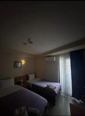 a hotel room with two beds and a window at grand life hotel in Corlu