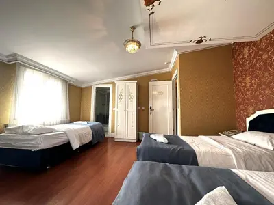 a hotel room with two beds and a window at Hotel Alyon Beyoğlu in Istanbul