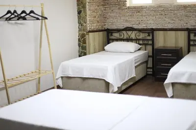 a bedroom with two beds and a brick wall at Detached villa with a heated pool and garden in Sapanca