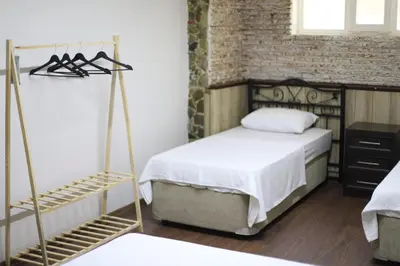 a bedroom with two beds and a brick wall at Detached villa with a heated pool and garden in Sapanca