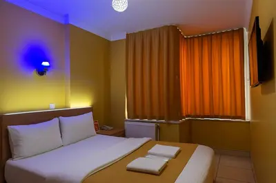 a bedroom with a bed with two towels on it at ESEN Life HOTEL in Istanbul