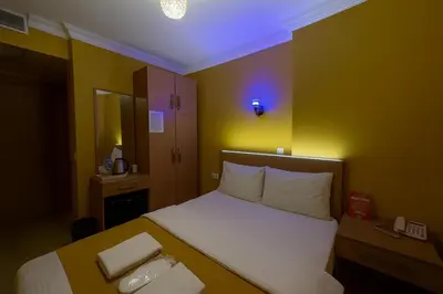 a bedroom with a bed with two towels on it at ESEN Life HOTEL in Istanbul