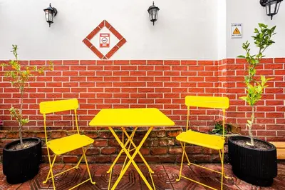 a table and four chairs in front of a brick wall at Timeless House Overlooking the Golden Horn with Sea - Nilorayn in Istanbul