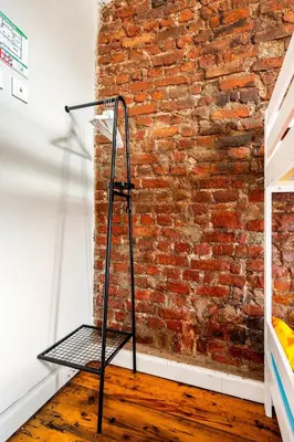 a metal stand in front of a brick wall at Timeless House Overlooking the Golden Horn with Sea - Nilorayn in Istanbul
