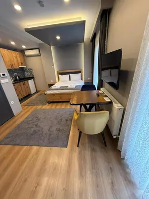 a bedroom with a bed and a table and a bed at AYD Apartment Taksim in Istanbul