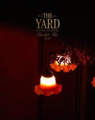 a light in the dark with a sign that reads the yard at The Yard Hotel in Istanbul