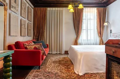 a hotel room with a bed and a red couch at The Yard Hotel in Istanbul