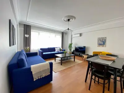 a living room with a blue couch and a table at Central Location 3 Bedroom Flat - No6 in Istanbul
