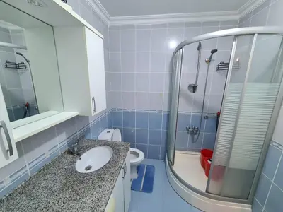 a bathroom with a sink and a shower and a toilet at Specius Flat Near Yeditepe Univ in Istanbul