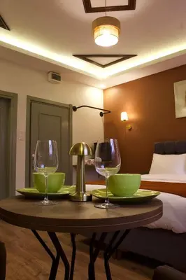 a table with two wine glasses on it in a hotel room at PeraHomes DE in Istanbul
