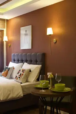 a bedroom with a bed and a table with wine glasses at PeraHomes DE in Istanbul