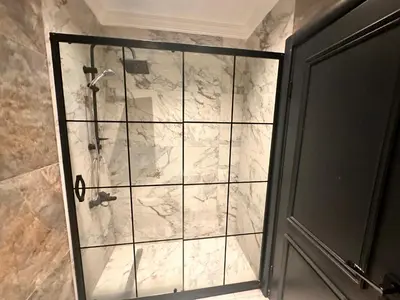 a shower with a glass door in a bathroom at Riddim apartment in Istanbul