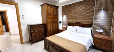 a bedroom with a large bed and a wooden wall at Taksim Flat in Istanbul