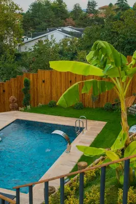 a swimming pool in a yard next to a fence at Localita Sapanca in Sapanca