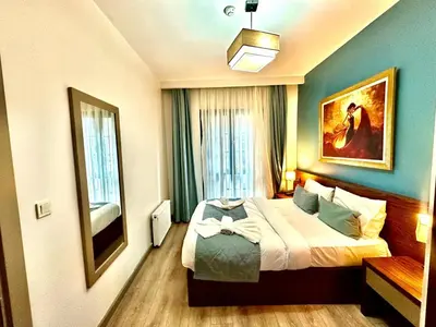 a bedroom with a bed and a painting on the wall at Taksim Luxury Beyoğlu Suites in Istanbul