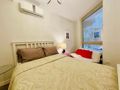 a bedroom with a large bed and a window at Beyoglu Hacımimi Gardens içinde özel bahçeli daire in Istanbul