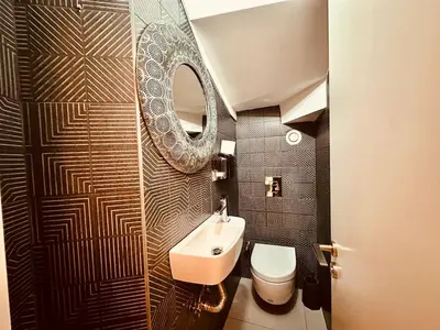 a bathroom with a sink and a toilet and a mirror at Beyoglu Hacımimi Gardens içinde özel bahçeli daire in Istanbul