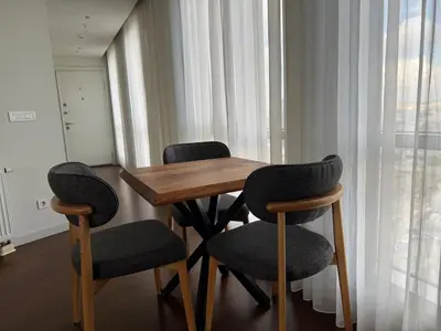 a wooden table with two chairs and a table with a window at CIFT MANZARa in Istanbul