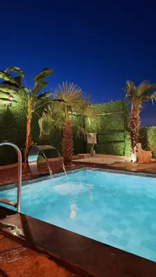 a swimming pool in a yard with palm trees at Reborn sapanca in Sapanca