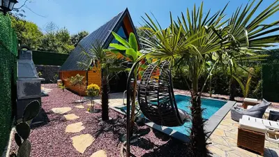 a backyard with a playground with a swing and palm trees at Reborn sapanca in Sapanca