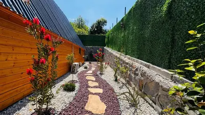 a garden with red flowers and a fence at Reborn sapanca in Sapanca