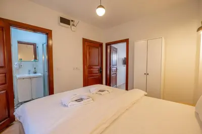 a bedroom with a large white bed and a bathroom at New homes oldcity in Istanbul