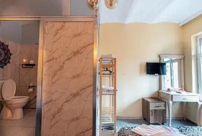 a bathroom with a shower with a toilet and a sink at Galata Comfortable 12 Suits in Istanbul