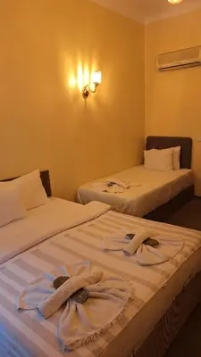 two beds with towels on them in a room at Galata Comfortable 12 Suits in Istanbul