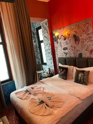 a bedroom with a bed with two towels on it at Galata Comfortable 12 Suits in Istanbul