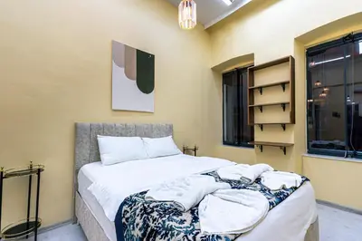 a bedroom with a bed with towels on it at Galata Comfortable 12 Suits in Istanbul