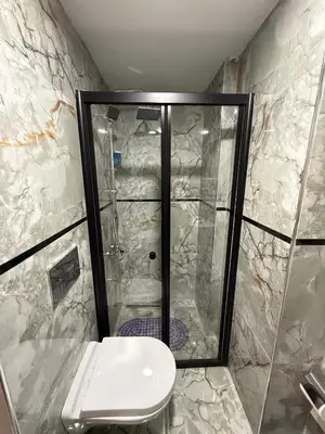 a shower stall with a toilet in a bathroom at Atay Apart in Istanbul
