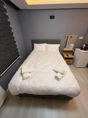 a bed with two slippers on it in a room at Atay Apart in Istanbul