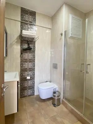 a bathroom with a shower and a toilet and a sink at Kerpe Diem Otel in Kerpe