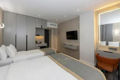 a hotel room with a bed and a television at Tumar Istanbul Hotel in Istanbul