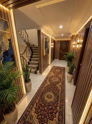 a hallway with a rug and stairs with plants at B Corner Hotel Bistro in Istanbul