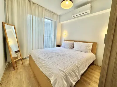 a bedroom with a bed with white sheets and a window at New apartment in the center of Istanbul near Istiklal in Istanbul