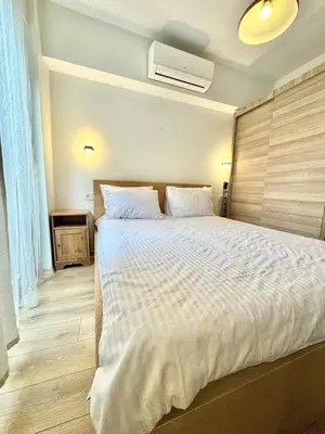 a bedroom with a large bed with a white comforter at New apartment in the center of Istanbul near Istiklal in Istanbul