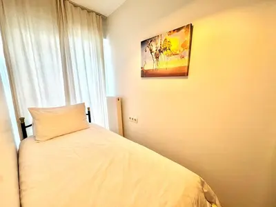 a bedroom with a bed and a painting on the wall at New apartment in the center of Istanbul near Istiklal in Istanbul