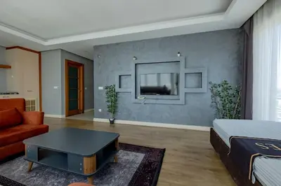a bedroom with a bed and a couch and a table at My SUİTES in Istanbul