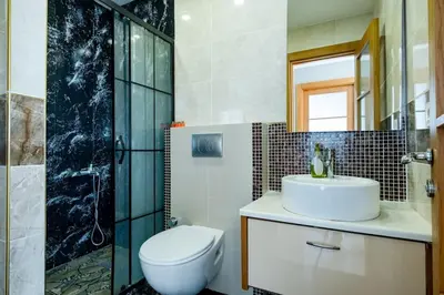 a bathroom with a toilet and a sink and a shower at My SUİTES in Istanbul