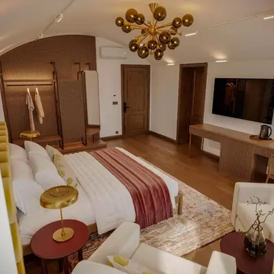 a bedroom with a large bed and a living room at Castellion Hotels Galata in Istanbul