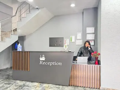 a woman talking on a phone at a reception at ergene park hotel